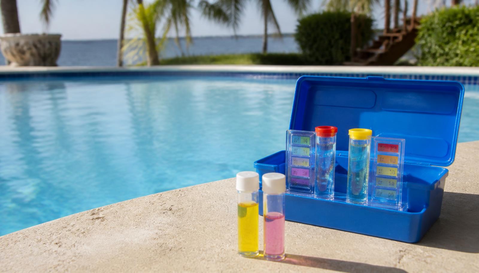 Pool water test kit and sample vials on the coping of a residential Florida pool