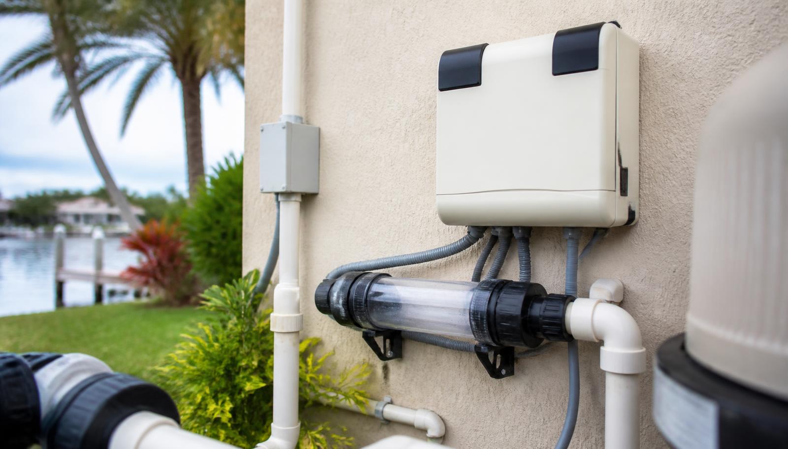 Salt chlorine generator cell and control unit at a residential Florida pool equipment pad